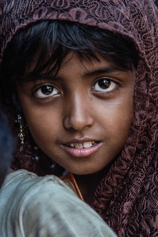 Portrait of a Girl, Kutupalong Refugee Camp, Bangladesh: close portrait of a girl in a patterned headscarf looking into the camera. Photograph by Marcus Vallance.