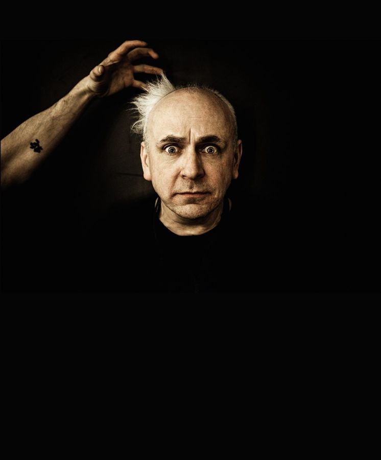 Lord Hagos Haggerty, London, UK: a man emerging from darkness with a hand reaching over his head. Photograph by Marcus Vallance.