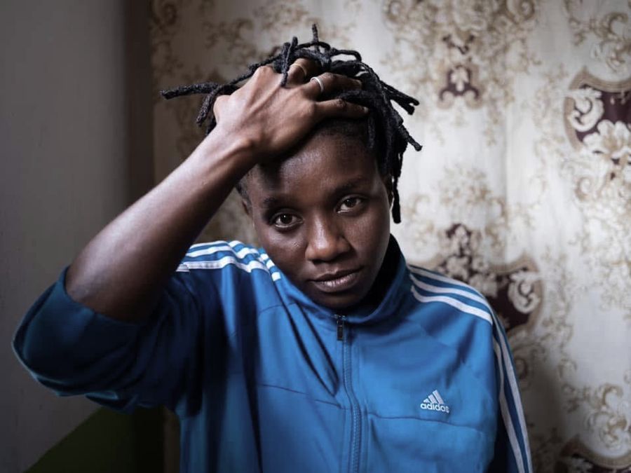 Mwajuma, Zanzibar, Tanzania: a young person in a blue tracksuit top, one hand on their head. Photograph by Marcus Vallance.