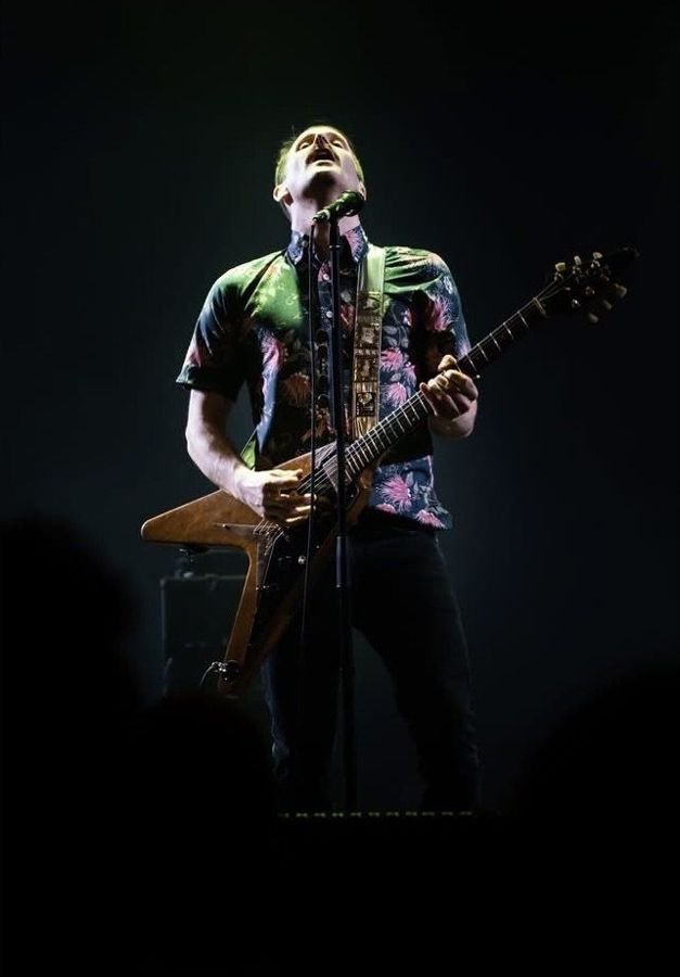 Tim Wheeler, Netherlands: a guitarist on a dark stage, head thrown back at the microphone. Photograph by Marcus Vallance.