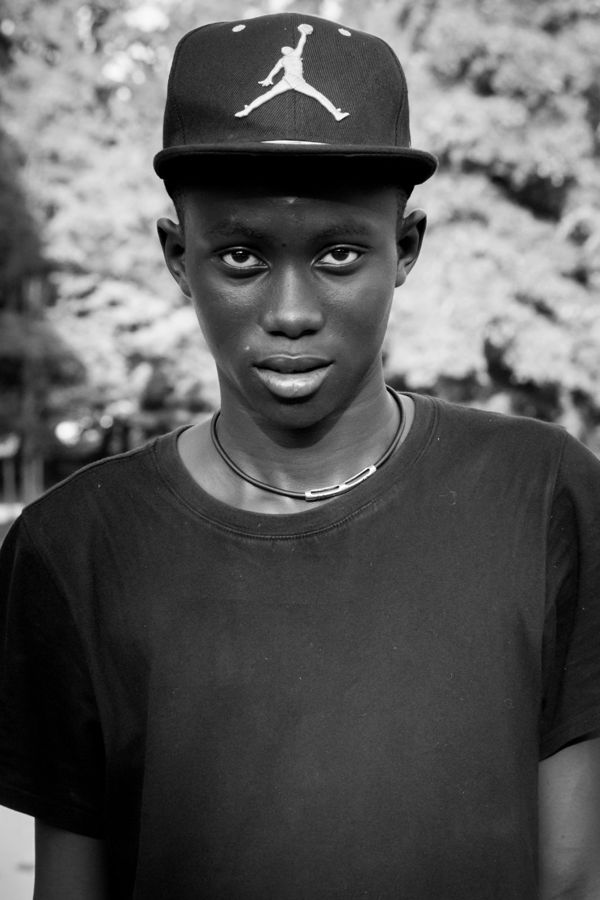 Portrait of a Boy, Milan, Italy: black and white portrait of a young man in a cap looking into the camera. Photograph by Marcus Vallance.