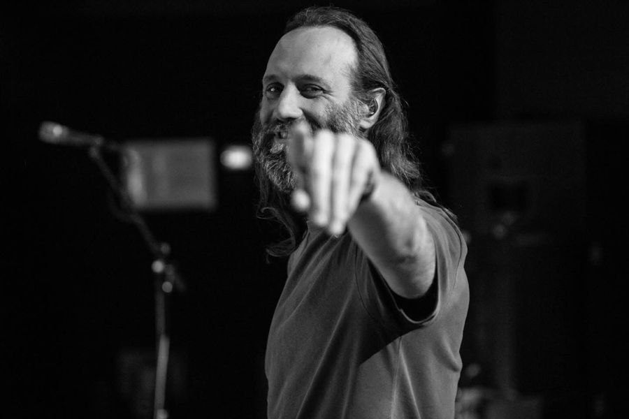 Gary Stringer, Amsterdam, Netherlands: black and white photograph of a singer on stage pointing at the camera. Photograph by Marcus Vallance.