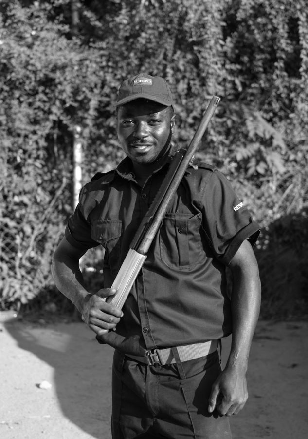 Security Guard, Zambia: black and white portrait of a uniformed guard. Photograph by Marcus Vallance.